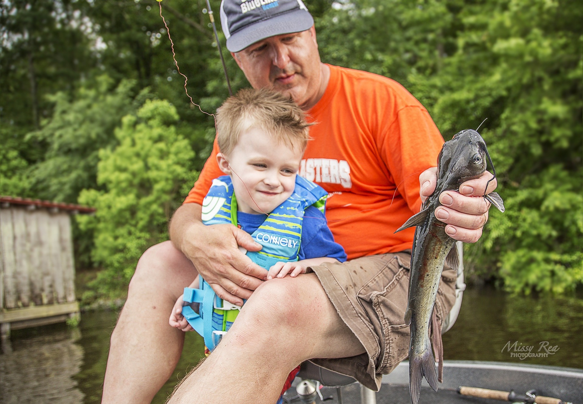 dad and son holding a fish