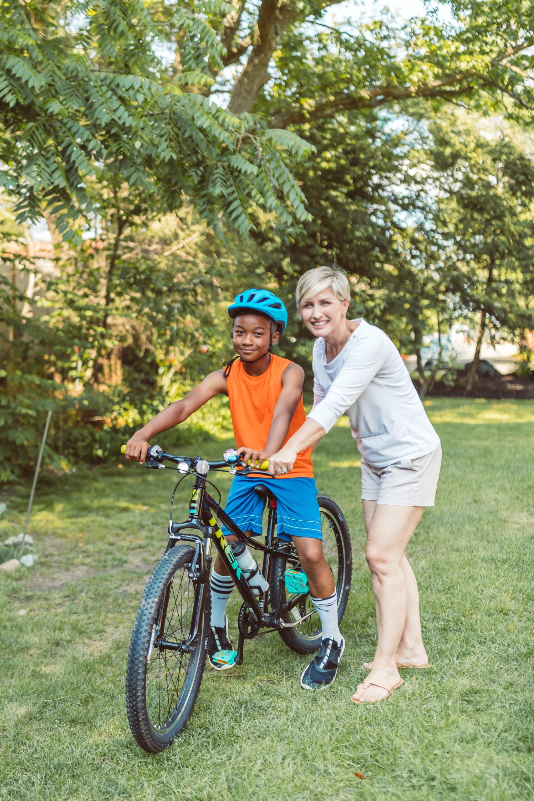 parent guiding child on bike